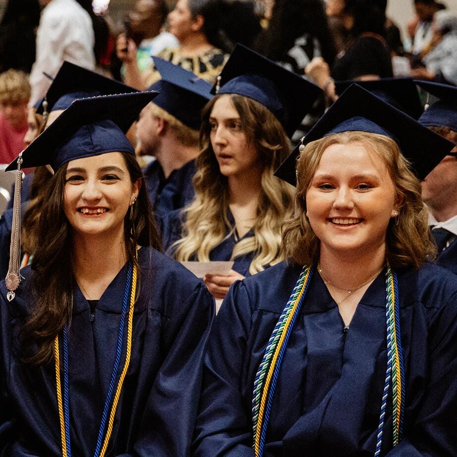 Graduated students smiling at the camera